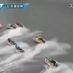 まくろうとする長尾章平をブロックする鈴木博